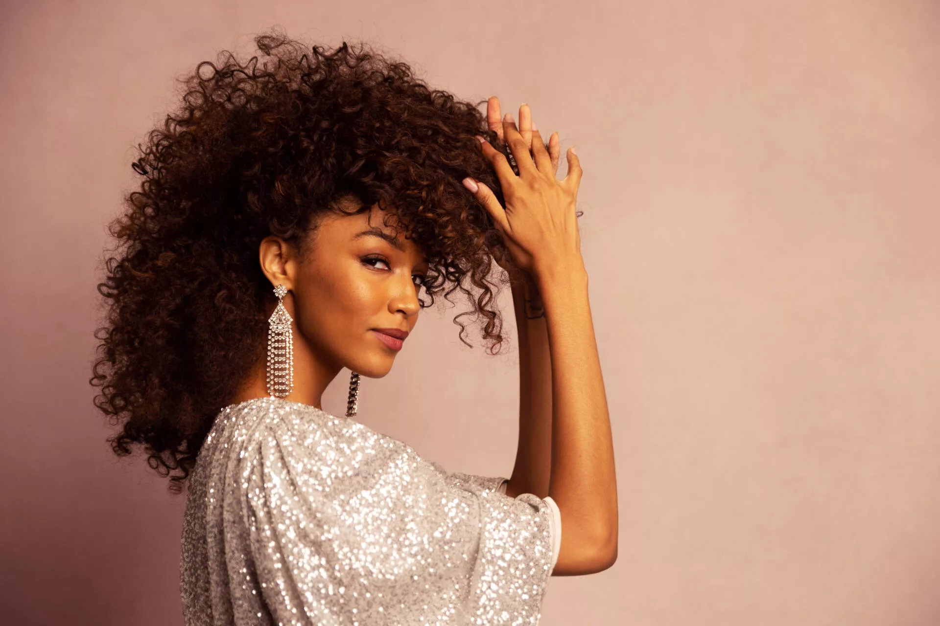A young pretty woman wearing a shiny outfit, in a unique curly hairstyle, posing for a magazine photo - Model Headshot, Tokyo Portrait Photographer, Photographer in Tokyo